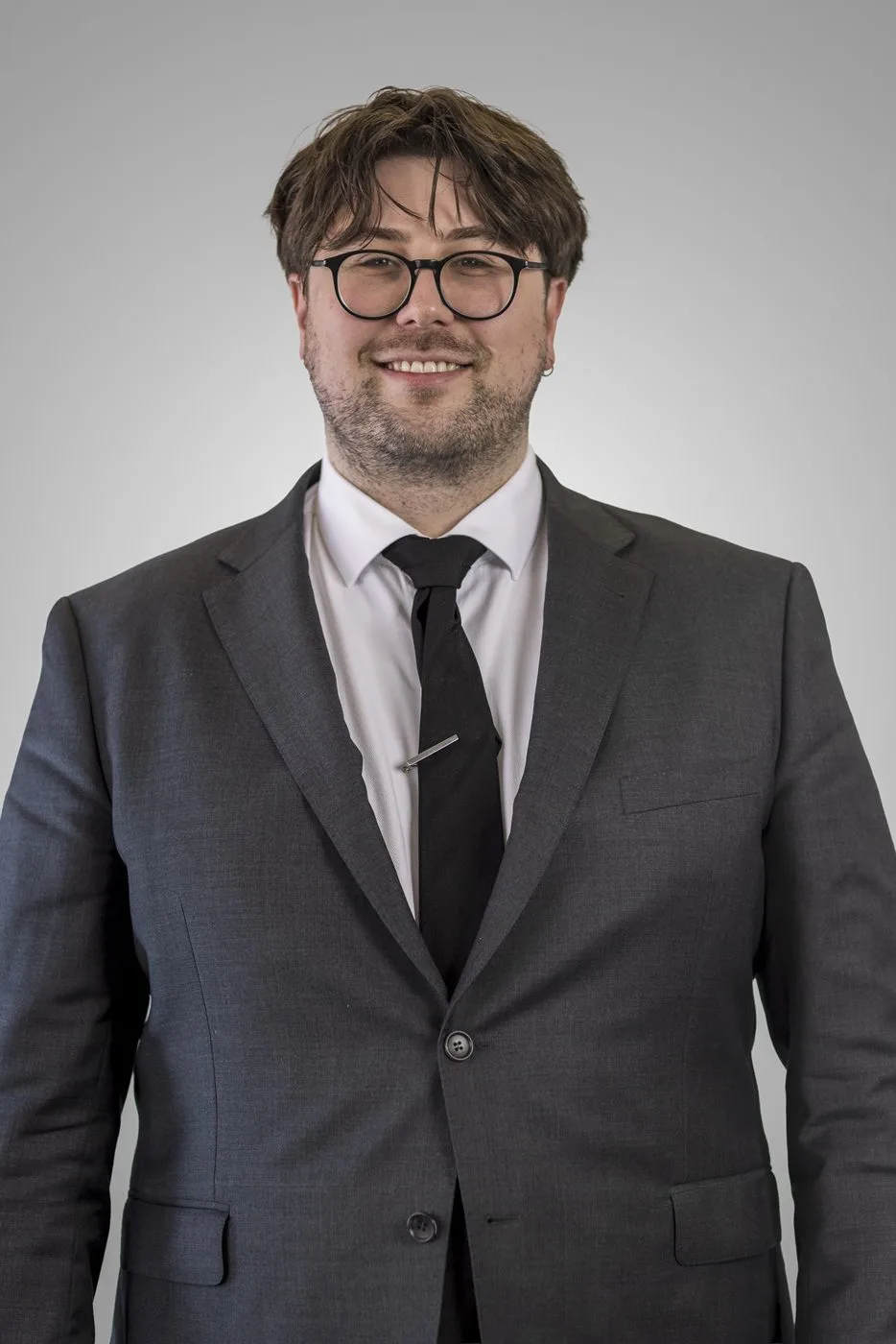 Sam Lambeff | Solicitor – Family Law, Wills & Estates | Looking smart wearing a suit and stylish glasses
